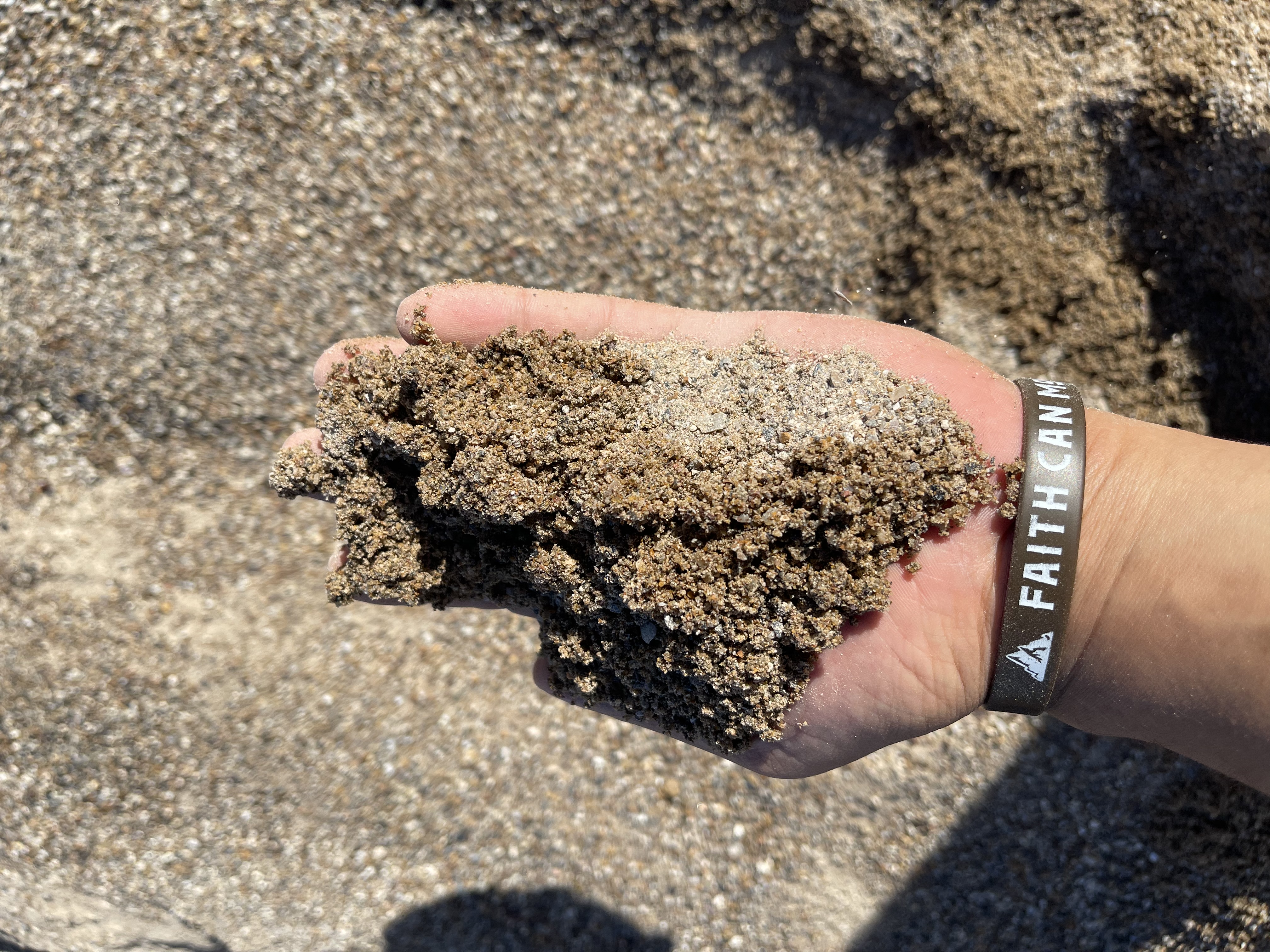 Close-up of crushed limestone and basalt showing the angular grade in hand